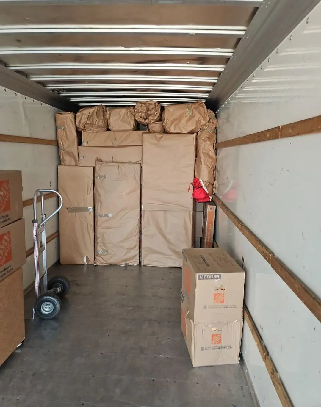 Wrapped furniture and boxes loaded inside a moving truck