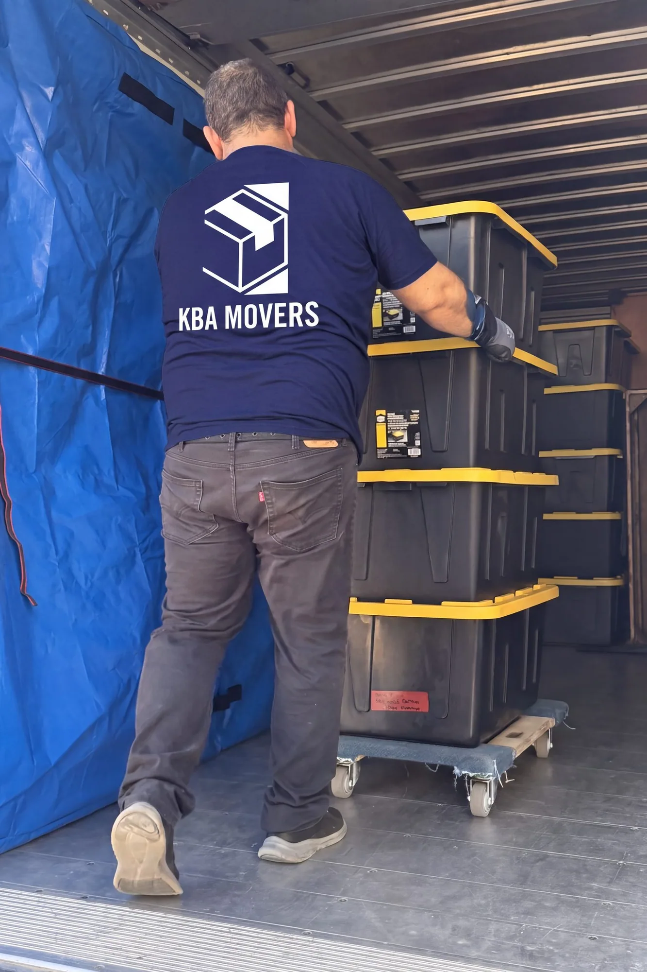Mover loading stacked storage totes into a moving truck